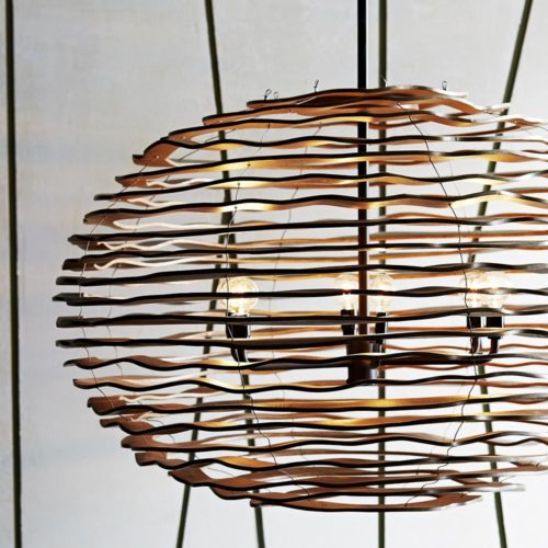 This pendant is a great example of how concentric circles can influence product design. These hand-carved undulating wood circles are arranged to create a contemporary open sphere finished in a gray-wash.