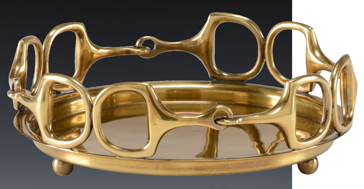 Beautiful hand-cast brass serving tray. This serving tray features an elegant stirrup design in antique brass finish. This versatile tray can find a home in a coffee or cocktail table and will look gorgeous on a bar or kitchen setting