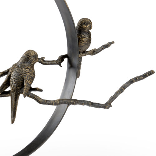 Bird sculpture made from hand wrought iron and a bronze finish on top of a natural black stone base