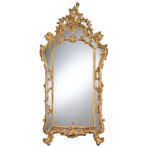 This stylish mirror is hand-crafted in Baroque style from carved wood. Decorative mirror is finished with hand applied gold metal leaf. Design of the mirror features classic dual frame with scrolled leaf and flowers motif. This mirror is hand-crafted in Italy