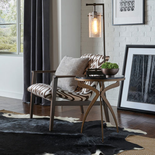 contemporary interior decor with elegant chair, floor lamp, and ccent table made of iron with a textured bronze finish and natural black marble top