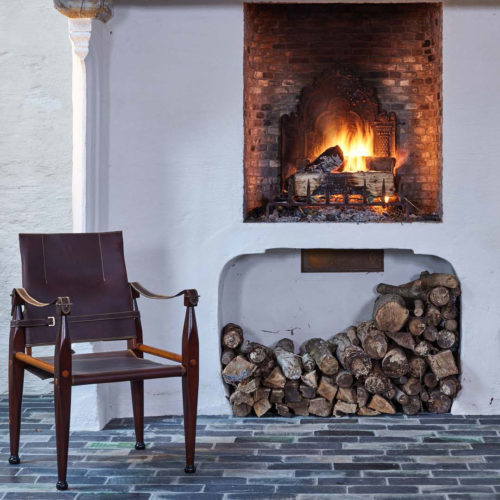 Bridle Leather Campaign chair by the fire