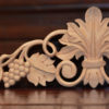 The spiral scrolling in a grape motif wood carving is the most generative figure in the history of carved wood ornaments