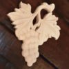 Wood carvings feature carved in deep relief grape clusters
