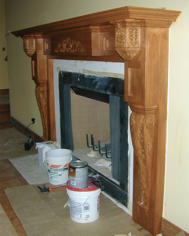 Classic fireplace mantel with corbels and carvings; interior design ideas