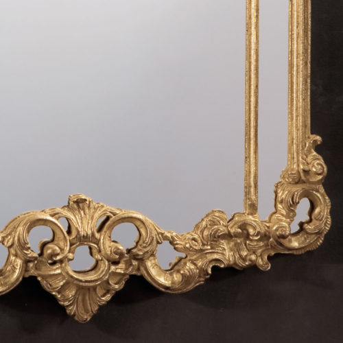 Neoclassic style carved wood decorative mirror with leaf scrolls design. Mirror finished in antiqued gold leaf. This mirror is hand-crafted in Italy