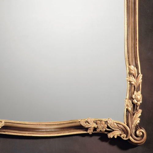 18th-century Tuscan style carved wood mirror with shell, leaf and floral carving. Framed mirror is hand-painted in medium brown finish and antiqued gold-leaf trim. This mirror is hand-crafted in Italy