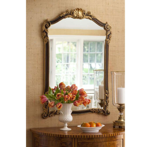 18th-century Tuscan style carved wood mirror with shell, leaf and floral carving. Framed mirror is hand-painted in medium brown finish and antiqued gold-leaf trim. This mirror is hand-crafted in Italy