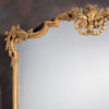 This horizontal wall mirror is hand-crafted in 18th century Tuscan style. Wall mirror has a carved wood frame with floral and leaf scrolls in antiqued hand applied gold metal leaf finish. This Tuscan style mirror is hand-crafted in Italy