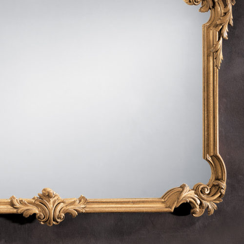 This horizontal wall mirror is hand-crafted in 18th century Tuscan style. Wall mirror has a carved wood frame with floral and leaf scrolls in antiqued hand applied gold metal leaf finish. This Tuscan style mirror is hand-crafted in Italy