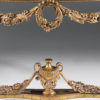 Louis XVI style carved wood console table with floral garland motif. Louis XVI console table has antiqued gold-leaf finish and Estremoz marble top with curved beveled edge. This console table is hand made in Italy