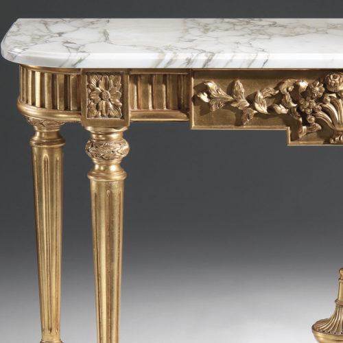 Louis XVI style carved wood console table. Louis XVI style console has carved floral motif, antique gold leaf finish and Calacatta gold marble top with carved beveled edge. This console table is hand made in Italy