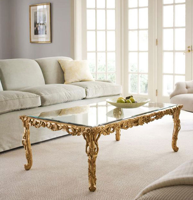 Living room decor featuring carved wood coffee table in gold leaf finish; available at InvitingHome.com