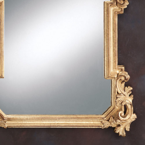 Carved wood Louis XIV style mirror with acanthus leaf motif. Mirror finished in antiqued gold leaf with burnish highlights. This mirror is hand-crafted in Italy