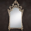 This elegant carved wood mirror is hand crafted in 18th century Italian style. Decorative wall mirror has floral design with graceful leaf scrolls and finished in antique silver leaf. This mirror is hand-crafted in Italy