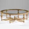 18th century French Neoclassic style round carved wood coffee table. Coffee table has hand-rubbed light gold finish and clear glass top. This coffee table is hand-made in Italy