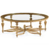 18th century French Neoclassic style round carved wood coffee table. Coffee table has hand-rubbed light gold finish and clear glass top. This coffee table is hand-made in Italy