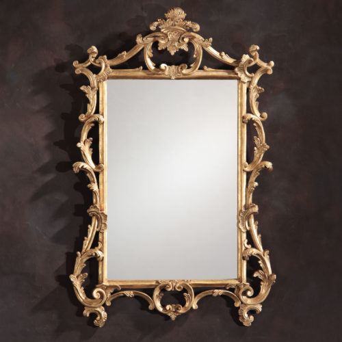 Chippendale style carved wood mirror with leaf and scroll design. This carved mirror finished in antiqued gold-leaf; hand-crafted in Italy