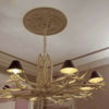 beautiful chandelier with ceiling medallion and panel molding on the ceiling