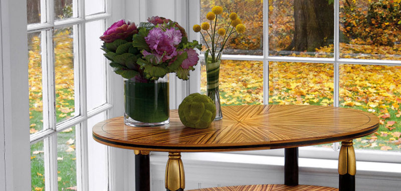 occasional tables; Room decor with Art Nouveau style oval wood accent table with one shelf, zebrawood veneer, black legs, antiqued goldleaf accents and brass ball feet; available at InvitingHome.com