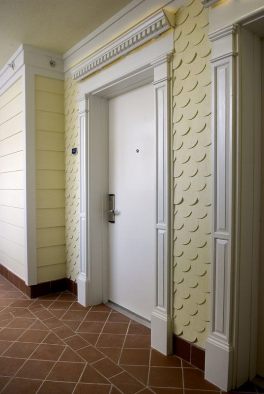 exterior doors trimed with paneled pilasters and dentil molding