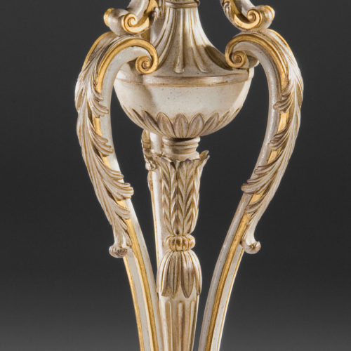 Majestically crafted in Regency style carved wood plant stand in antiqued black finish. Plant stand elaborately embellished with with floral swags, stylized pinecones, and elegantly scrolled leaf. All details are carved in deep relief and finished in hand applied gold metal leaf. Regency plant stand designed with solid brass liner