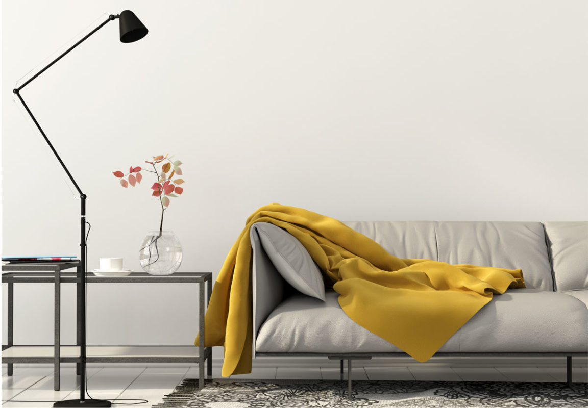 Modern setting with adjustable floor lamp, side table and slick couch;  modern decorating ideas