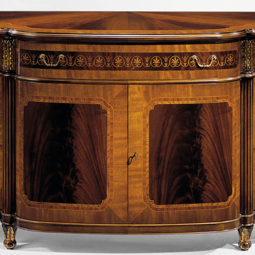 Hand-crafted Regency style four door inlaid credenza. This stunning credenza features mahogany veneer and cross-banded inlay of satinwood, rosewood and ash burl. Regency credenza has three inlaid drawers, three compartments with one shelf inside, carved wood capitals in antiqued gold-leaf finish and antiqued brass hardware. This inlaid credenza is hand-made in Italy