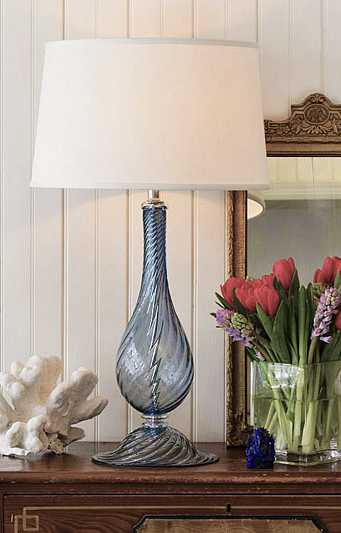 Beautiful interior with hand-blown transparent blue Venetian glass lamp with swirl design and round hardback fabric shade; made in Murano, Italy; available at InvitingHome.com