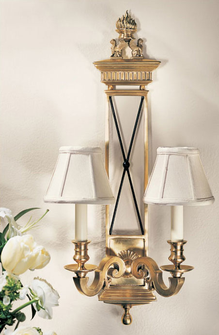brass wall sconce with black trim lions and flame motif; wall decor ideas; wall lighting