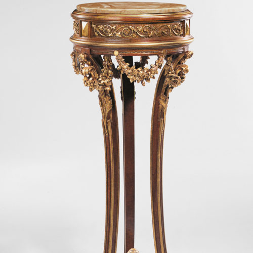 This carved wood pedestal is hand crafted in Italy in 19th century Empire style. Pedestal has a square top and base. Carved wood pedestal has a walnut finish
