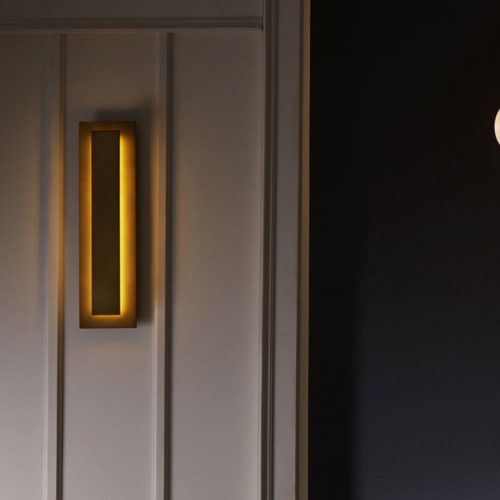 Sleek and stylish, the modern form of this antique brass sconce offers a clean and streamlined visual to a wall space. The rectangular profile lends a contemporary touch to traditional lighting designs, and its steel form delivers a slight industrial appeal