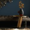 contemporary wall decor with dark blue accent wall and antique brass accents