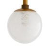Varying sizes of opal swirl glass globes embellish a sleek and slender steel frame that works to ground the slightly whimsical design. Small, clearcrystal knobs contrast beautifully with the antique brass finish