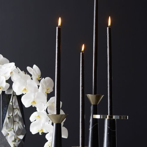 elegant table setting featuring two black marble candlesticks.