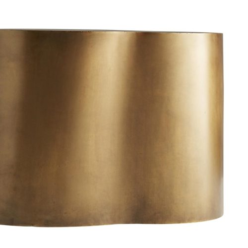 playful curves dance around the entire structure of this cocktail table, softening its skilled metal craftsmanship. Look closely and discover a warm antique brass finish