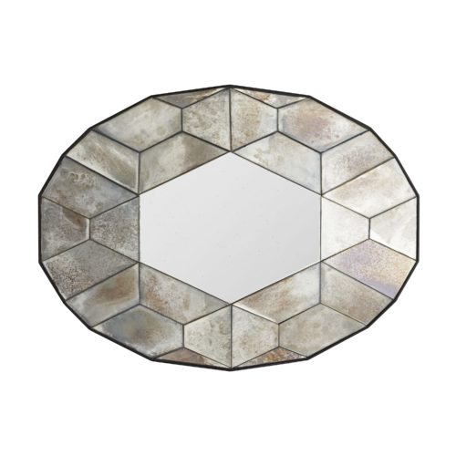 A unique geometric pattern surrounds the hexagon-shaped glass center, creating a reflective tortoiseshell appearance. Framed in natural iron, the heavily antiqued, outermirrored panels provide warm and cool tones that accentuate a more lightly antiqued, and functional central mirror.
