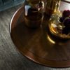 gold glass vases sits atop elegant coffee table