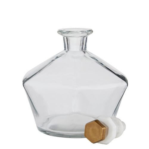 play on geometrics and the mix of materials that work together to create this decanter set is quite brilliant. Lead glass with a clear finish creates a crystalline effect that accentuates the sophisticated white marble and antique brass stoppers, each decanter bearing a unique shape. Evoking classic elements of style and design,