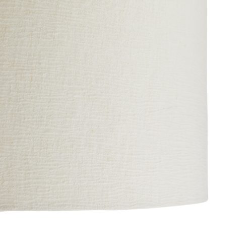 The crinkle shade and umber finish work in unison to accent the textures of the natural wood grain. The neutral hue and natural material make it a versatile piece that functions alongside a variety of décor styles. Topped with an off-white linen drum shade with off-white cotton lining.