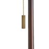 Sleek and sophisticated, this double-socket iron floor lamp features a slender metal column supported by a round open-base foot in an antique brass finish.