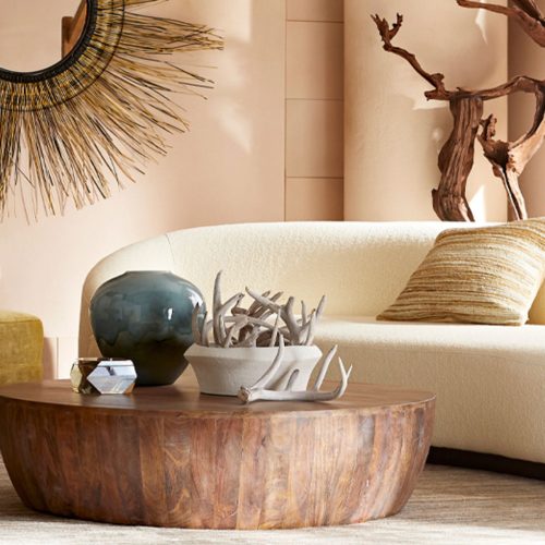 modern living room with round wood coffee table and decorative accents.