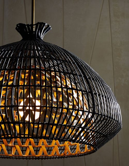Svelte. Sleek. Sophisticated. This large-scale pendant brings romantic and moody light to a space while showcasing its own curvy and sultry style. It's built with two layers; the interior form is made of naturally finished woven rattan slatson a metal frame and the outer shade is woven with rattan core strips that are finished in black.