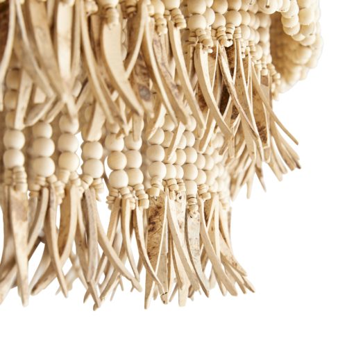 The layered concentric construction is crafted from wood and coconut beads that are strung along an antique brass frame, showcasing a mélangeof neutral hues. Coconut shell talons hang from the wood bead strands.