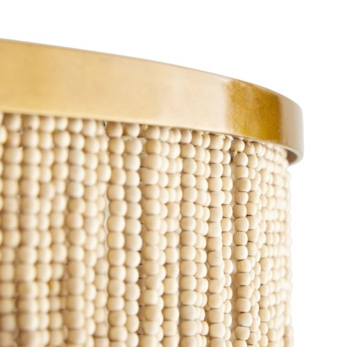 The layered concentric construction is crafted from wood and coconut beads that are strung along an antique brass frame, showcasing a mélangeof neutral hues. Coconut shell talons hang from the wood bead strands.
