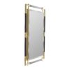The details of this mirror's linear frame balance masculine and feminine aesthetics to create a refined statement piece. A reflective mirror trimmed with a beveled edge is surrounded by brass arms in a brushed finish that extend from the glassto create a see-through effect. Navy leather wrapping adorns segments of the brilliant metal frame, adding natural charm to its luxe appeal.