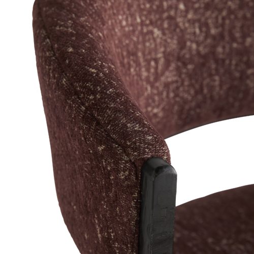A curved back and large seat rest on a perfectly poised iron frame to compose the foundation of this burgundy chenille chair. The seat and back cushion are covered in a bordeaux chenille fabric, subtly showcasing the contrast of highs and lows evident in its rich hue.
