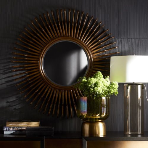 modern and mixed materials. These decorative accents are perfectly paired. Smoke luster glass centerpiece with rattan burst wall mirror.