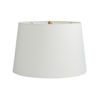 An exaggerated antique brass stem reveals an oversized white orb foundation composed of rice stone.A functional art piece in its simplest form for traditional and modern settings. Topped with an ivory microfiber drum shade with ivory cotton lining and a 1