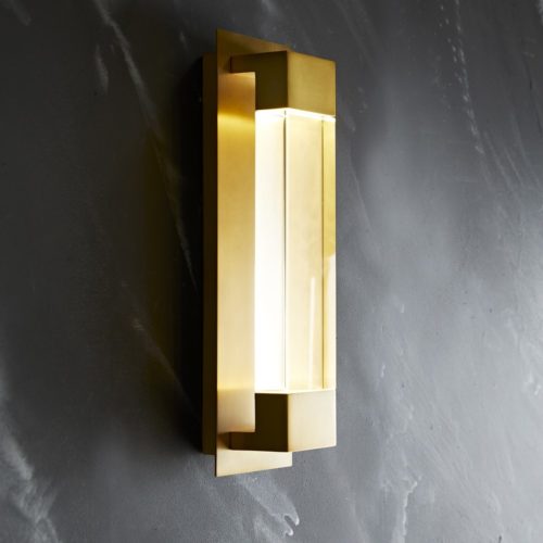 Elevate a wallspace with this contemporary sconce. A crystal, clear with a frosted backing and fashioned to an antique brass steel plate, offering a slightly industrial and very modern visual to a room. When in use, the material appear to glow thanksto the ultramodern LED light. Pair with another for a more cohesive look.